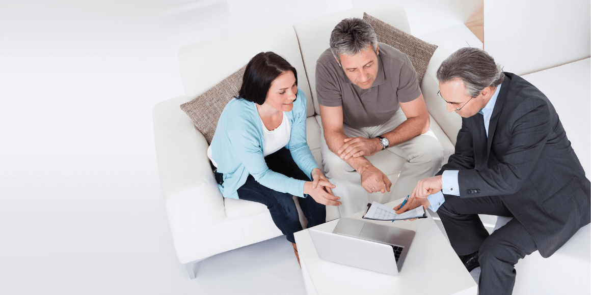 investor guiding man and woman through a contract on a laptop