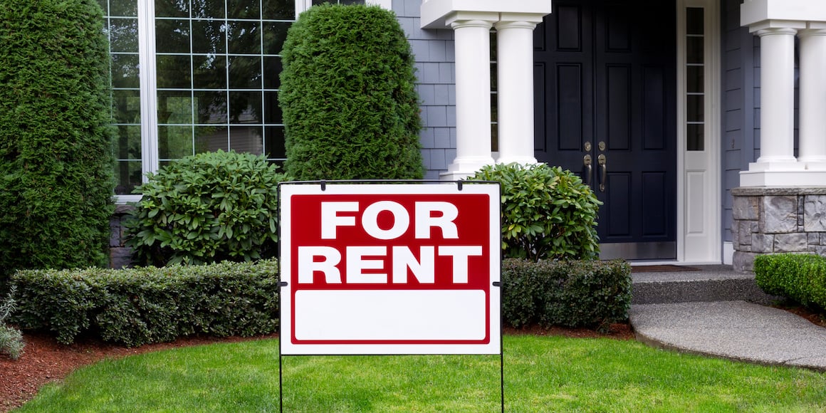 Beautiful residential home with a red for rent sign in the lawn