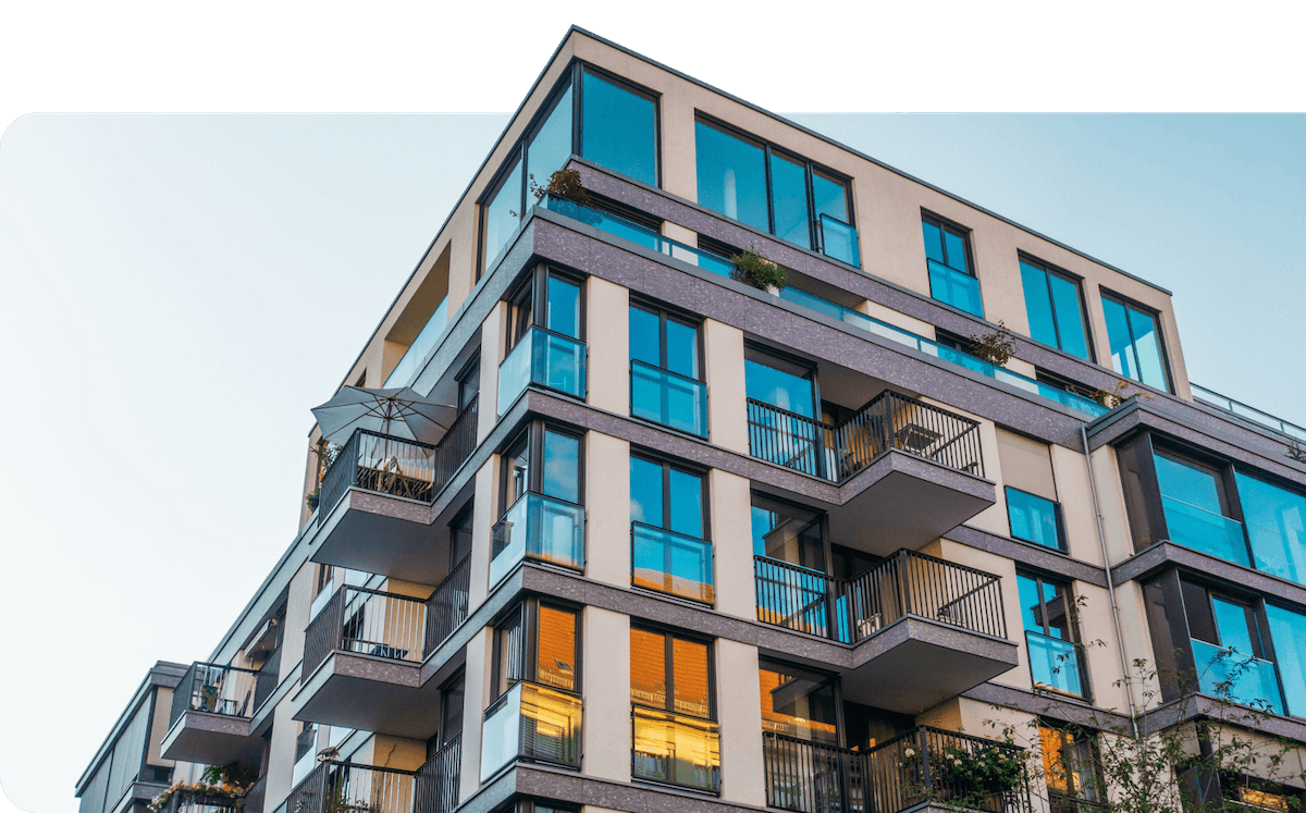 An apartment building contrasted against a blue sky